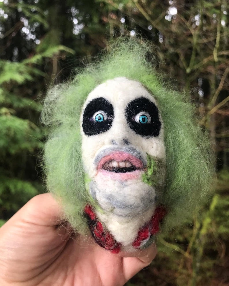 A needle felted portrait magnet of Beetlejuice