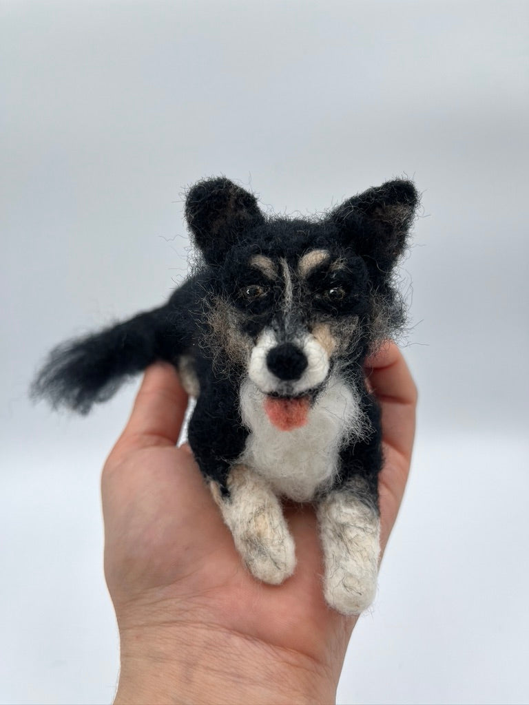 A needle felted pet portrait of a black fluffy dog