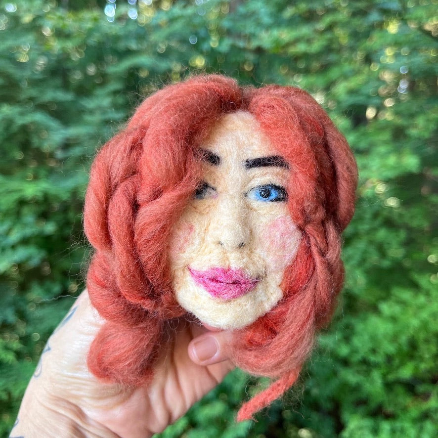 A needle felted portrait magnet of Tori Amos