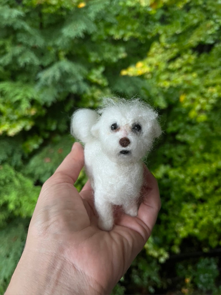 A needled felted pet portrait of a white dog