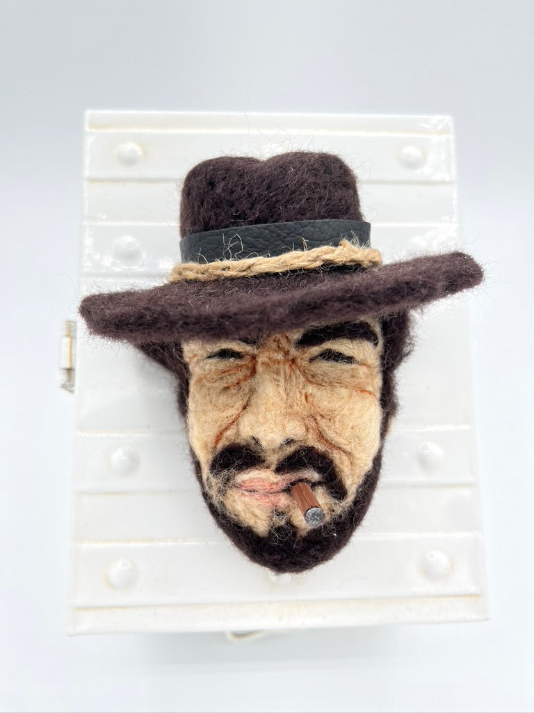 A needle felted portrait magnet of Clint Eastwood