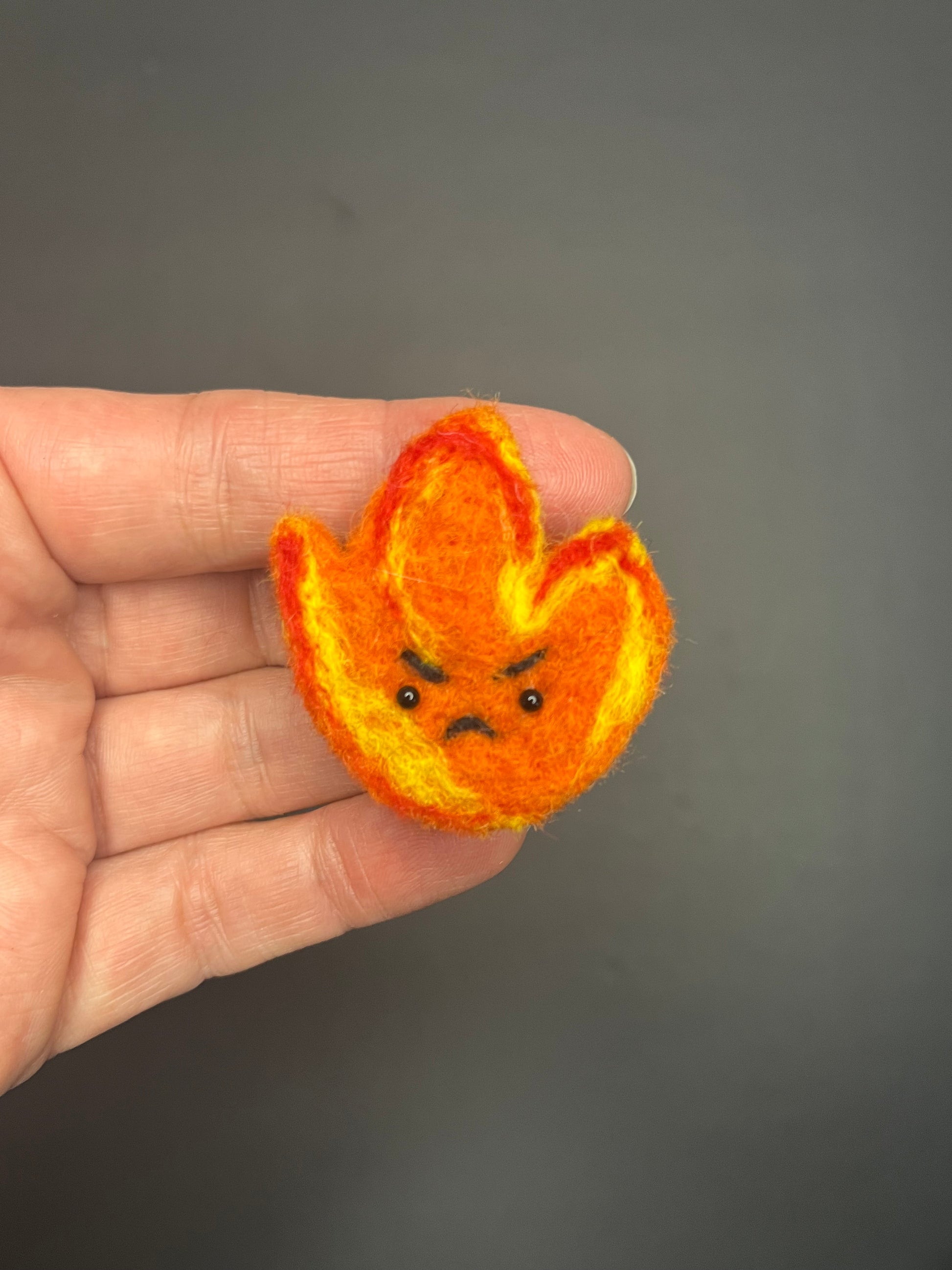 Adorable needle felted grumpy flame pin 